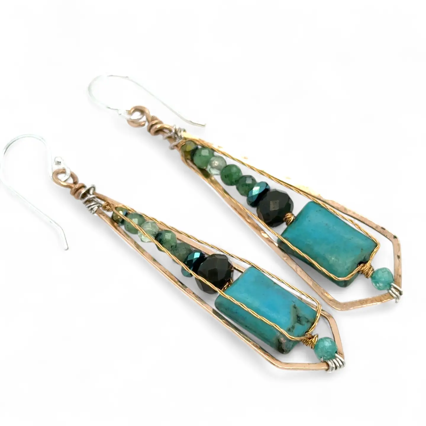 Turquoise smooth rectangles topped with crystal, pyrite, and ruby zoisite gemstones in a long bronze diamond earrings with brass twist accent
