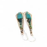 Turquoise smooth rectangles topped with crystal, pyrite, and ruby zoisite gemstones in a long bronze diamond earrings with brass twist accent