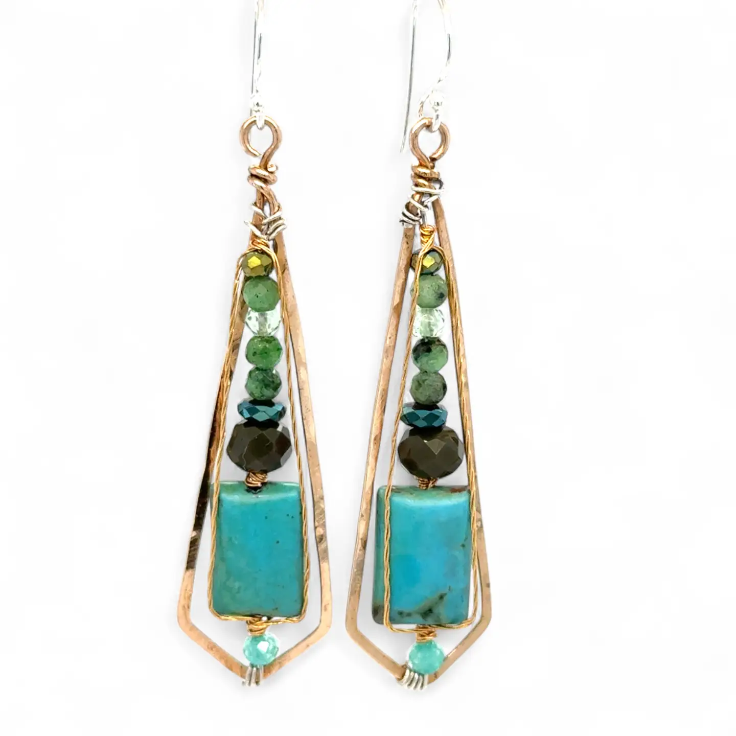 Turquoise smooth rectangles topped with crystal, pyrite, and ruby zoisite gemstones in a long bronze diamond earrings with brass twist accent