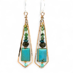 Turquoise smooth rectangles topped with crystal, pyrite, and ruby zoisite gemstones in a long bronze diamond earrings with brass twist accent