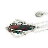 A hammered sterling silver diamond pendant hold a bloodstone faceted skinny drop accented with fancy jasper gemstones, held on a sterling silver dainty double chain necklace