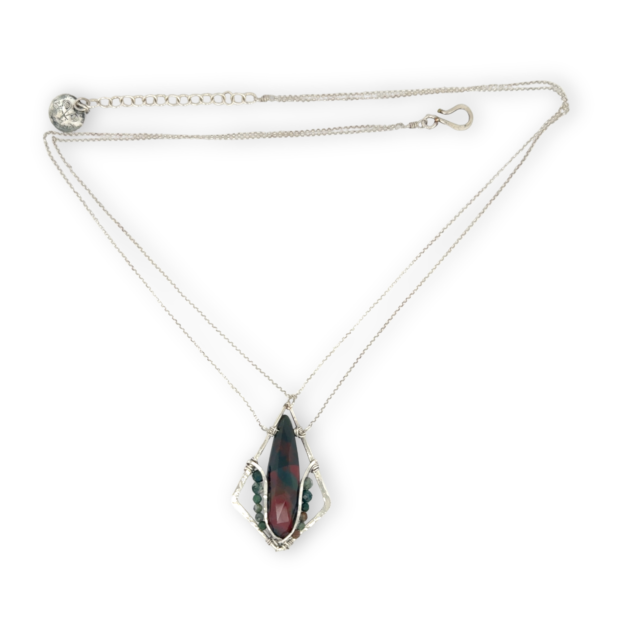 A hammered sterling silver diamond pendant hold a bloodstone faceted skinny drop accented with fancy jasper gemstones, held on a sterling silver dainty double chain necklace