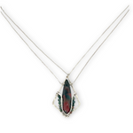 A hammered sterling silver diamond pendant hold a bloodstone faceted skinny drop accented with fancy jasper gemstones, held on a sterling silver dainty double chain necklace