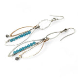 A pair of dangling earrings with sterling silver and bronze semi-circle elements, accented with tiny faceted aqua cat's eye gemstones and labradorite dangles