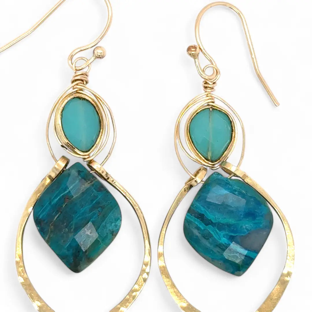 A pair of gold-colored brass earrings with a double drop design, featuring blue green chrysocolla marquise gemstones and chalcedony wrapped in gold filled wire