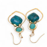 A pair of gold-colored brass earrings with a double drop design, featuring blue green chrysocolla marquise gemstones and chalcedony wrapped in gold filled wire
