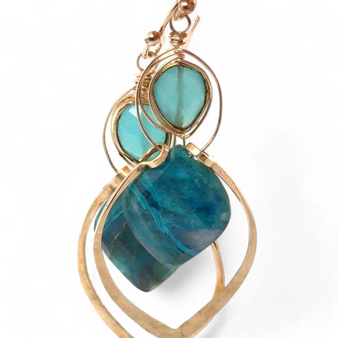 A pair of gold-colored brass earrings with a double drop design, featuring blue green chrysocolla marquise gemstones and chalcedony wrapped in gold filled wire