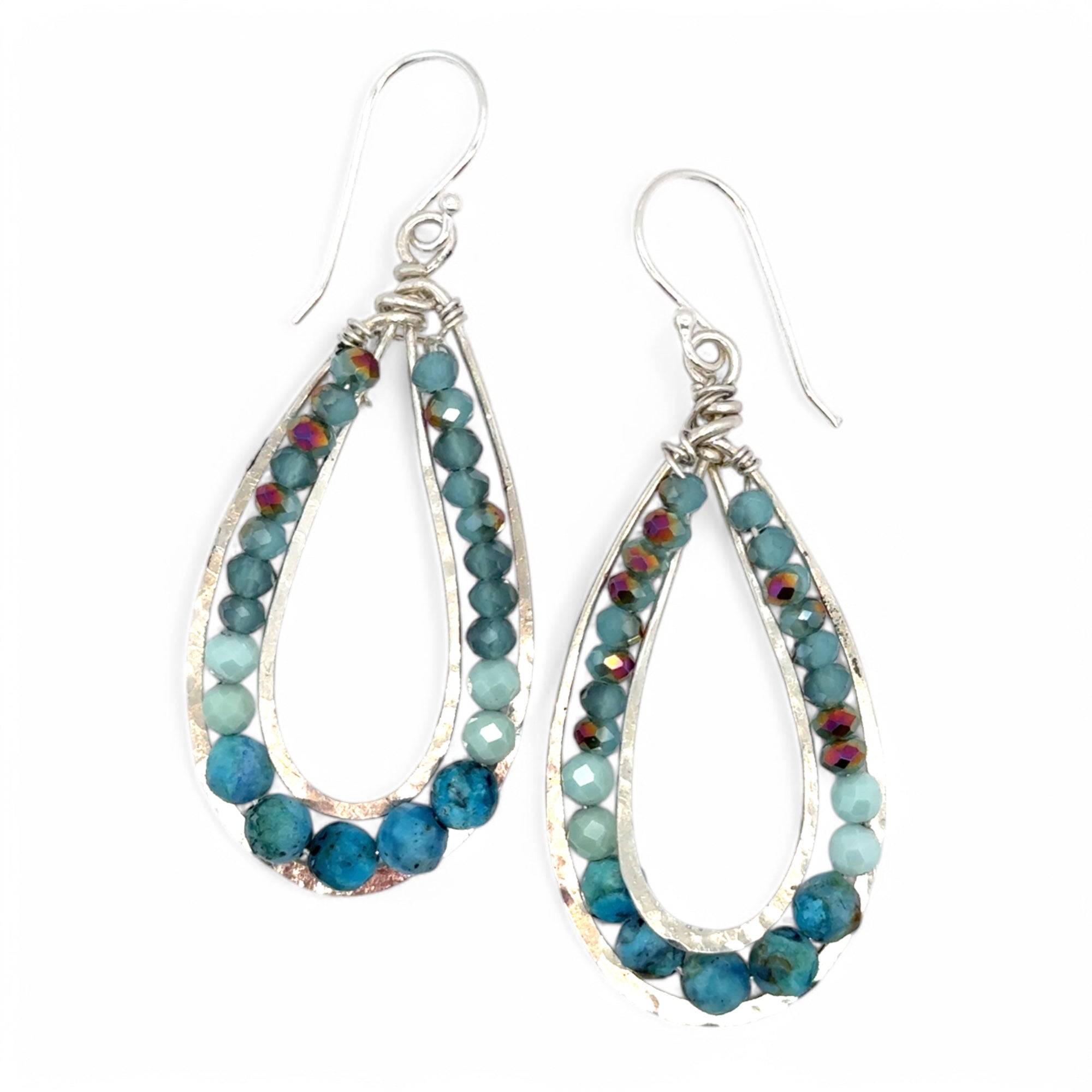 A pair of teardrop-shaped sterling silver channel earrings featuring blue opal and larimar gemstones with blue crystal