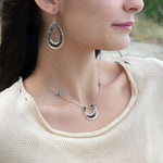 Mini sterling silver horseshoe shaped pendant filled with emerald, amazonite, blue tourmaline, and green amethyst gemstones, with a gold filled and sterling dot chain with pyrite accents necklace