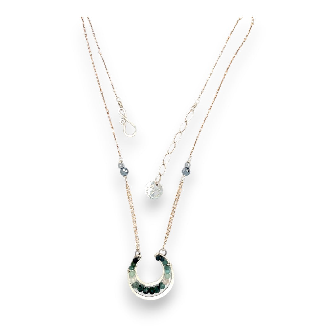Mini sterling silver horseshoe shaped pendant filled with emerald, amazonite, blue tourmaline, and green amethyst gemstones, with a gold filled and sterling dot chain with pyrite accents necklace