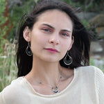 Mini sterling silver horseshoe shaped pendant filled with emerald, amazonite, blue tourmaline, and green amethyst gemstones, with a gold filled and sterling dot chain with pyrite accents necklace