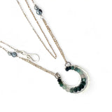 Mini sterling silver horseshoe shaped pendant filled with emerald, amazonite, blue tourmaline, and green amethyst gemstones, with a gold filled and sterling dot chain with pyrite accents necklace