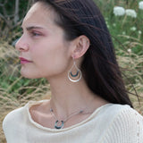 Mini sterling silver horseshoe shaped pendant filled with emerald, amazonite, blue tourmaline, and green amethyst gemstones, with a gold filled and sterling dot chain with pyrite accents necklace