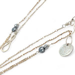 Mini sterling silver horseshoe shaped pendant filled with emerald, amazonite, blue tourmaline, and green amethyst gemstones, with a gold filled and sterling dot chain with pyrite accents necklace