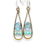 A pair of twisted brass drop earrings featuring blue crystal, amazonite and apatite gemstones 