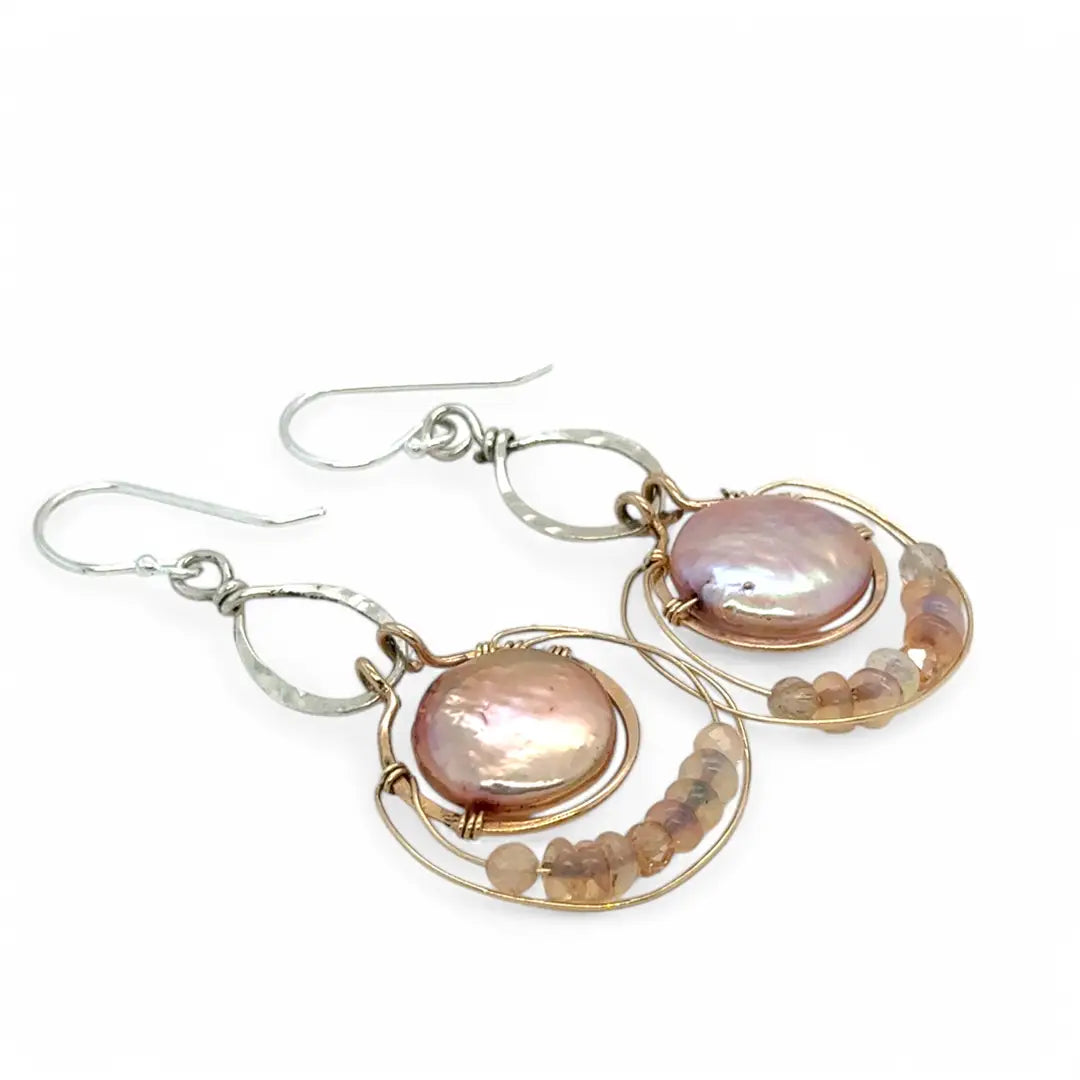 pink fresh water pearl coins are held in bronze rings on hammered sterling silver drops with rings of gold filled wire holding pink opal and peach cat's eye gemstone earrings