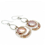 pink fresh water pearl coins are held in bronze rings on hammered sterling silver drops with rings of gold filled wire holding pink opal and peach cat's eye gemstone earrings