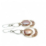 pink fresh water pearl coins are held in bronze rings on hammered sterling silver drops with rings of gold filled wire holding pink opal and peach cat's eye gemstone earrings