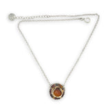 Necklace with a circular pendant featuring a central honey chalcedony stone and smaller mookaite jasper gemstones surrounding brass hammered wire