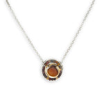 Necklace with a circular pendant featuring a central honey chalcedony stone and smaller mookaite jasper gemstones surrounding brass hammered wire