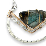 Leaf stamped sterling silver bowl shaped pendant with bronze v shape accents. A fan shaped flashy labradorite gemstone with fresh water pearl and micro-faceted gemstones and a sterling silver chain