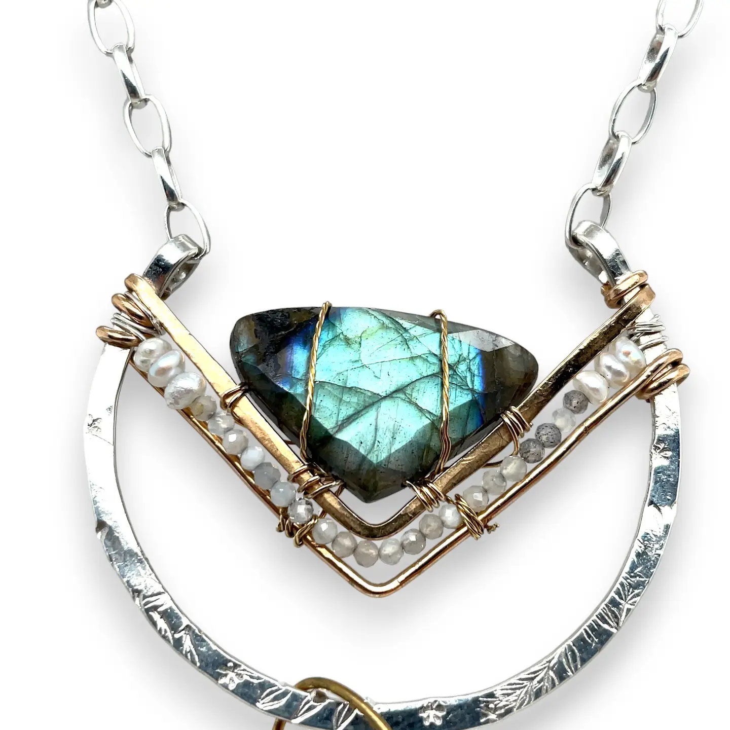 Leaf stamped sterling silver bowl shaped pendant with bronze v shape accents. A fan shaped flashy labradorite gemstone with fresh water pearl and micro-faceted gemstones and a sterling silver chain