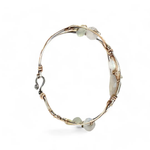 Sterling, darkened sterling, and bronze hammered waves form a cuff bracelet accented with moonstone, opal, fresh water pearl, and prehnite gemstones on gold filled wire