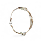 Sterling, darkened sterling, and bronze hammered waves form a cuff bracelet accented with moonstone, opal, fresh water pearl, and prehnite gemstones on gold filled wire