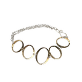 A brass oval link bracelet with a sterling silver double chain and side closure
