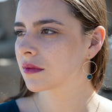 faceted apatite coin gemstone wrapped in gold filled wire held on a sterling silver handmade hoop