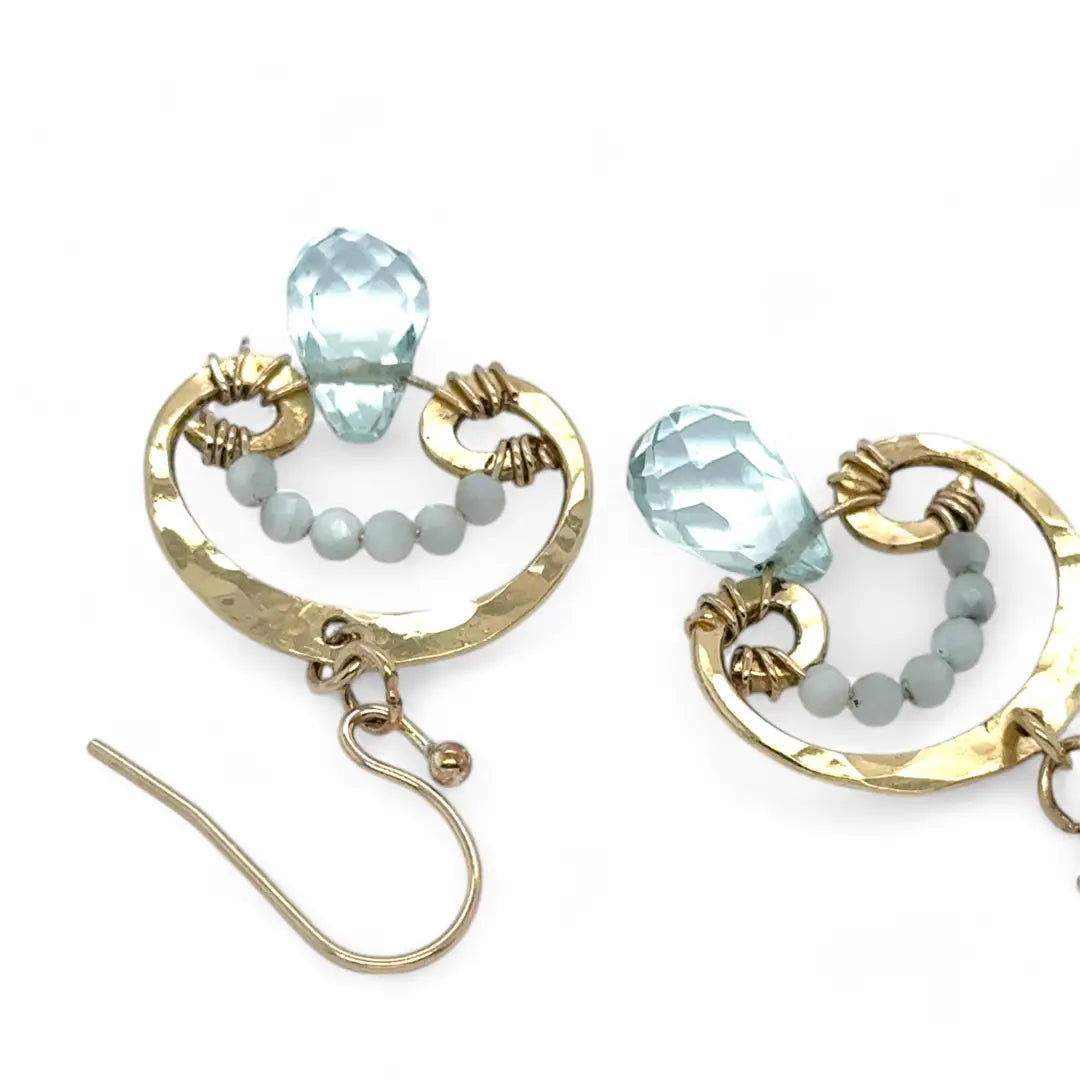 A pair of brass mini mushroom-shaped earrings with blue quartz gemstone drops and micro light blue cat's eye gemstones