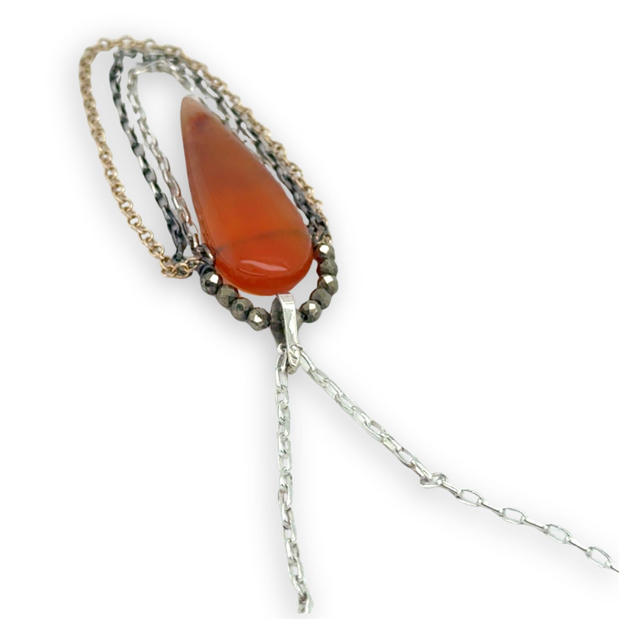 Smooth carnelian long drop with gold filled, sterling, and darkened sterling chain cascades on an arch or pyrite gemstones necklace
