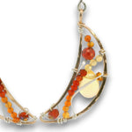 Bronze moon shaped earrings filled with carnelian, citrine, red cubic zirconia, and a citrine smooth teardrop on sterling silver wire