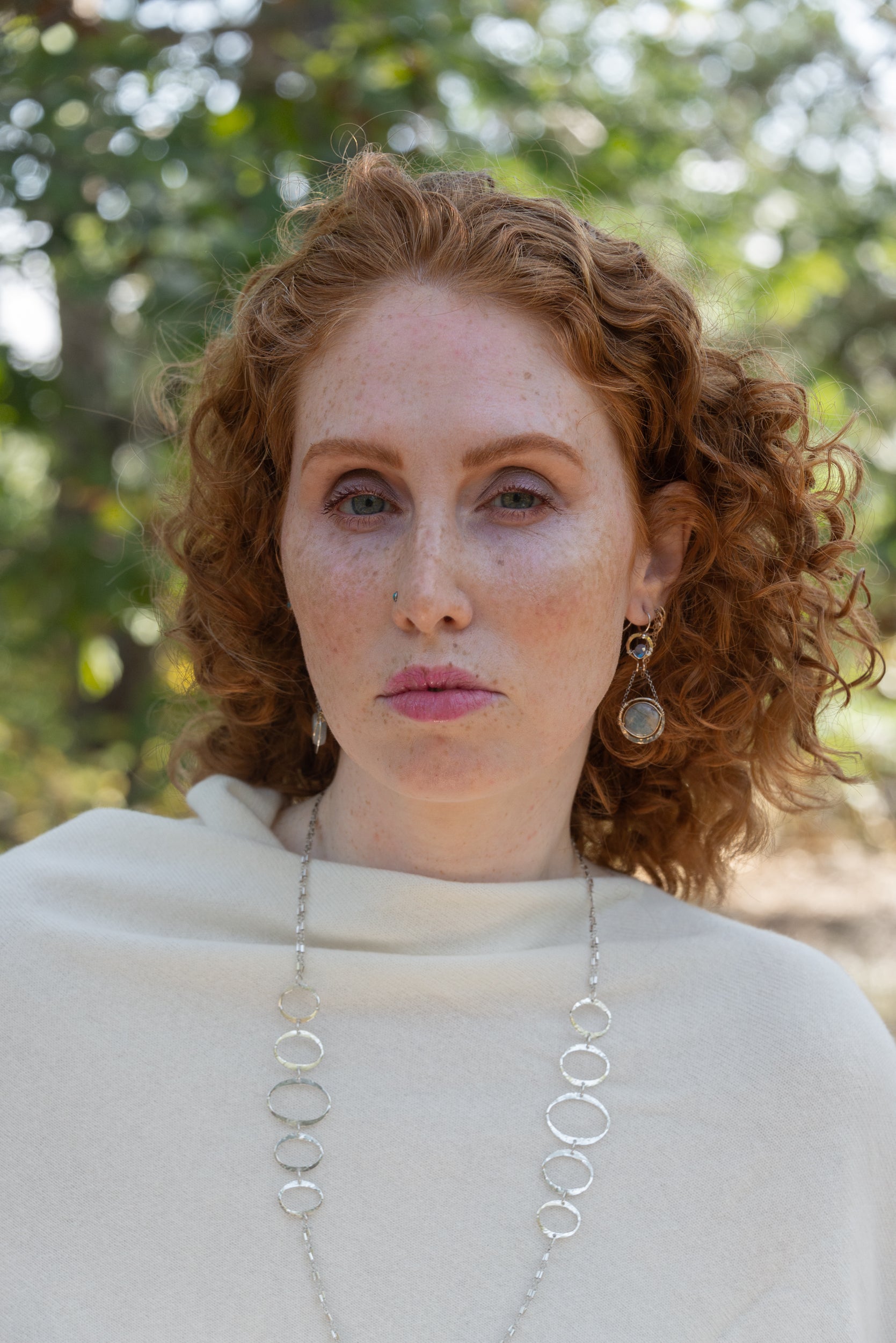 Sterling silver earrings with smooth aquamarine coins and crystal wrapped in gold-filled wire, accompanied by dainty sterling silver chain.