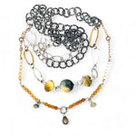 A double strand necklace with one strand featuring hammered brass and sterling silver handmade links and cat's eye faceted gemstones, and the other strand with faceted ombre mookaite and tiny pearl accents.