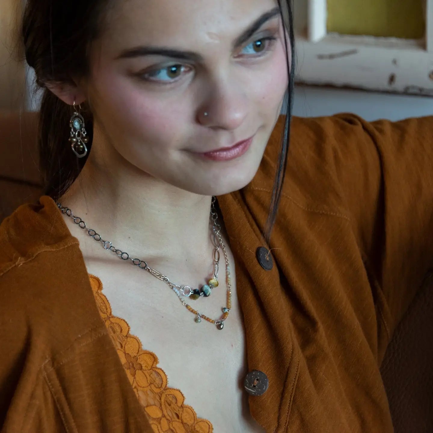 A double strand necklace with one strand featuring hammered brass and sterling silver handmade links and cat's eye faceted gemstones, and the other strand with faceted ombre mookaite and tiny pearl accents.