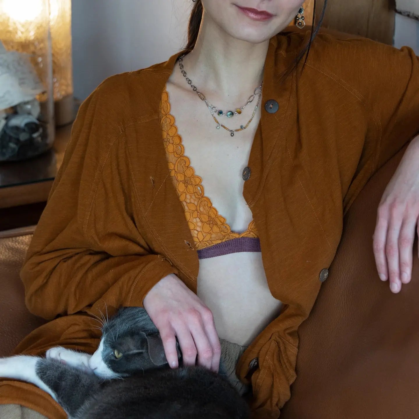 A double strand necklace with one strand featuring hammered brass and sterling silver handmade links and cat's eye faceted gemstones, and the other strand with faceted ombre mookaite and tiny pearl accents.