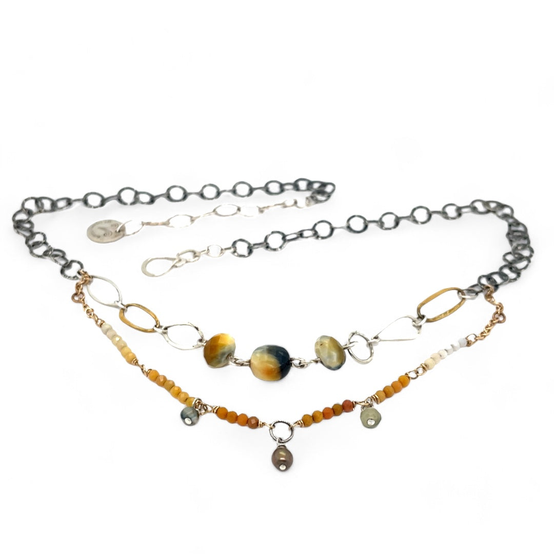 A double strand necklace with one strand featuring hammered brass and sterling silver handmade links and cat's eye faceted gemstones, and the other strand with faceted ombre mookaite and tiny pearl accents.