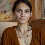 handmade hammered marquise links mixed with cat's eye gemstones, sparkly sterling silver links, and sterling silver chain form a long necklace