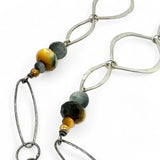 handmade hammered marquise links mixed with cat's eye gemstones, sparkly sterling silver links, and sterling silver chain form a long necklace