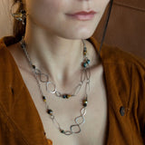 handmade hammered marquise links mixed with cat's eye gemstones, sparkly sterling silver links, and sterling silver chain form a long necklace