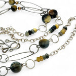 handmade hammered marquise links mixed with cat's eye gemstones, sparkly sterling silver links, and sterling silver chain form a long necklace