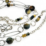 handmade hammered marquise links mixed with cat's eye gemstones, sparkly sterling silver links, and sterling silver chain form a long necklace