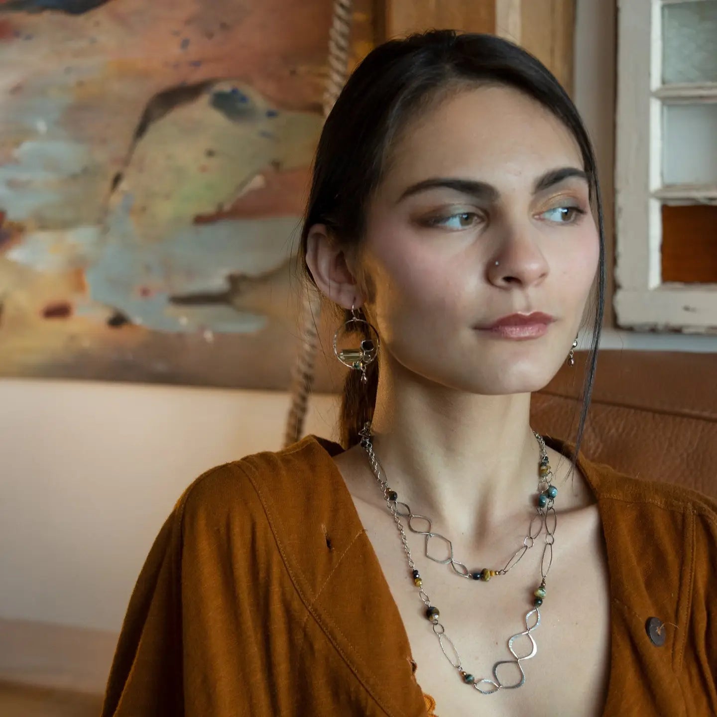 handmade hammered marquise links mixed with cat's eye gemstones, sparkly sterling silver links, and sterling silver chain form a long necklace