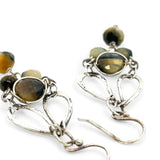 A pair of sterling silver chandelier earrings with cat's eye cut gemstones in various colors