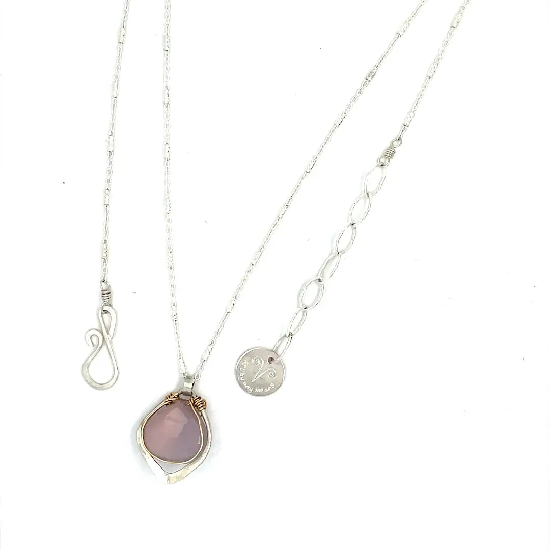 A sterling silver mini necklace with a teardrop-shaped pink chalcedony and sterling silver pendant on a sparkling sterling silver dash chain