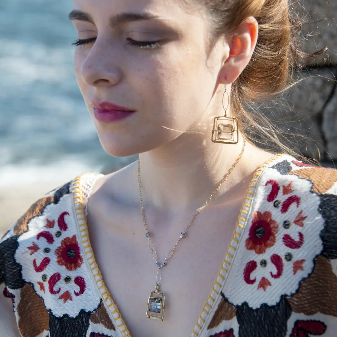 Champagne crystal tiles held in brass twist wire within a brass hammered square earring frame hanging from a sterling silver marquise link