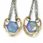 Handmade leaf stamped brass chariots hanging from double up oxidized sterling silver dainty chain, holding a blue faceted hexagonal crystal earring