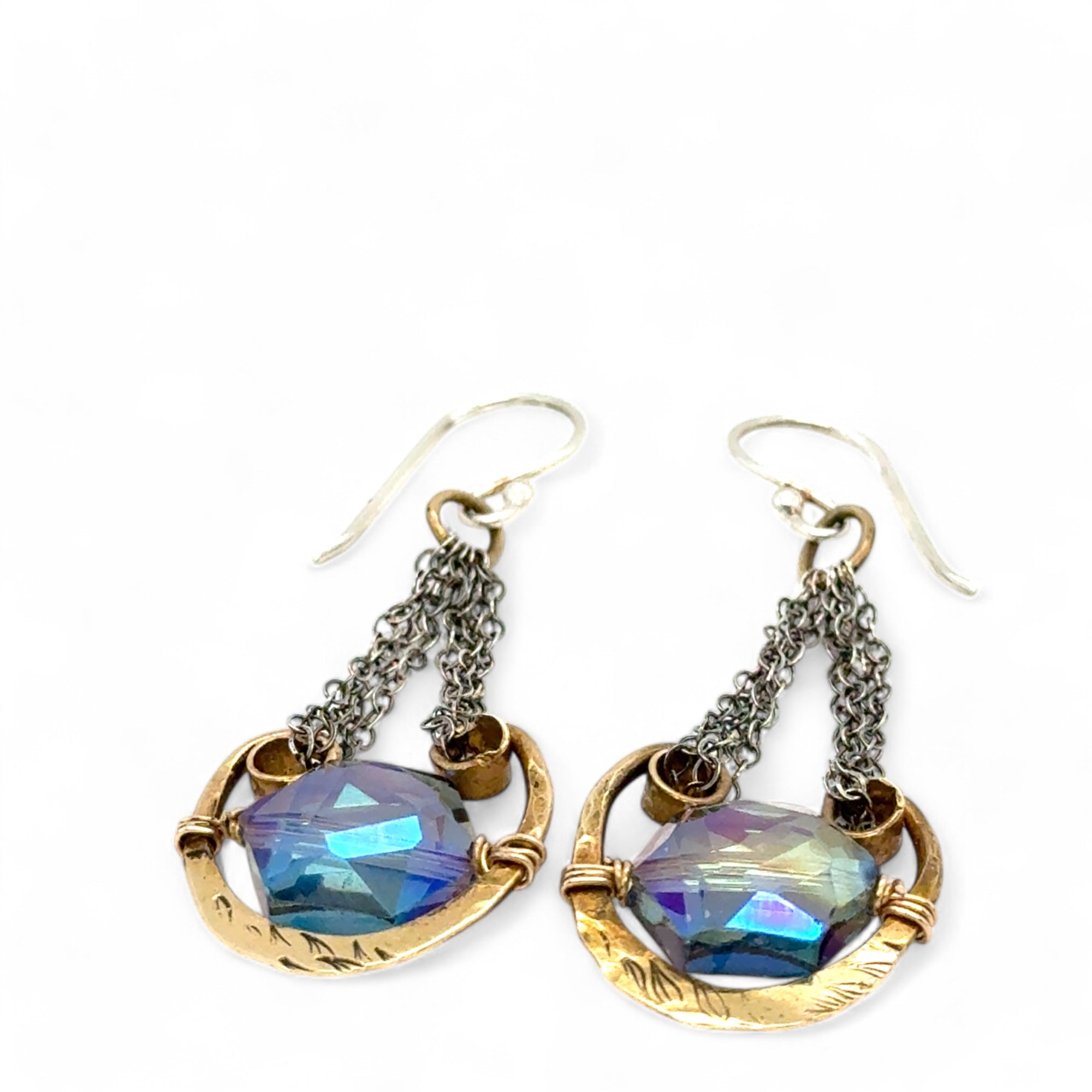 Handmade leaf stamped brass chariots hanging from double up oxidized sterling silver dainty chain, holding a blue faceted hexagonal crystal earring