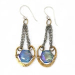 Handmade leaf stamped brass chariots hanging from double up oxidized sterling silver dainty chain, holding a blue faceted hexagonal crystal earring